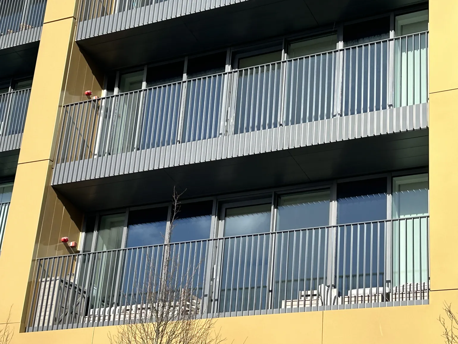BM Architectural supplied the sleek, fire-safe, aluminium railings installed at the edges of all balconies and terraces on the ‘New Victoria’ apartments in Manchester, UK.

The New Vic as it’s known following completion, is a luxury high-rise development comprising 520 new homes set across two towers, standing 20 and 25 storeys high. Designed for modern urban living, it offers residents premium amenities, including a co-working space, gym, cinema room, shared dining area, and a private roof garden.

Given the project's scale and constrained city-centre location, the balustrade solution needed to be lightweight and easy to install, in addition to being fully compliant with edge protection and fire safety regulations, and contribute to the bold architectural design. The EazyRail A2 Aluminium Railing system from BM Architectural, in both the J1 Juliet balcony style and the W2 version featuring a modern fascia plate, was the ideal choice.
